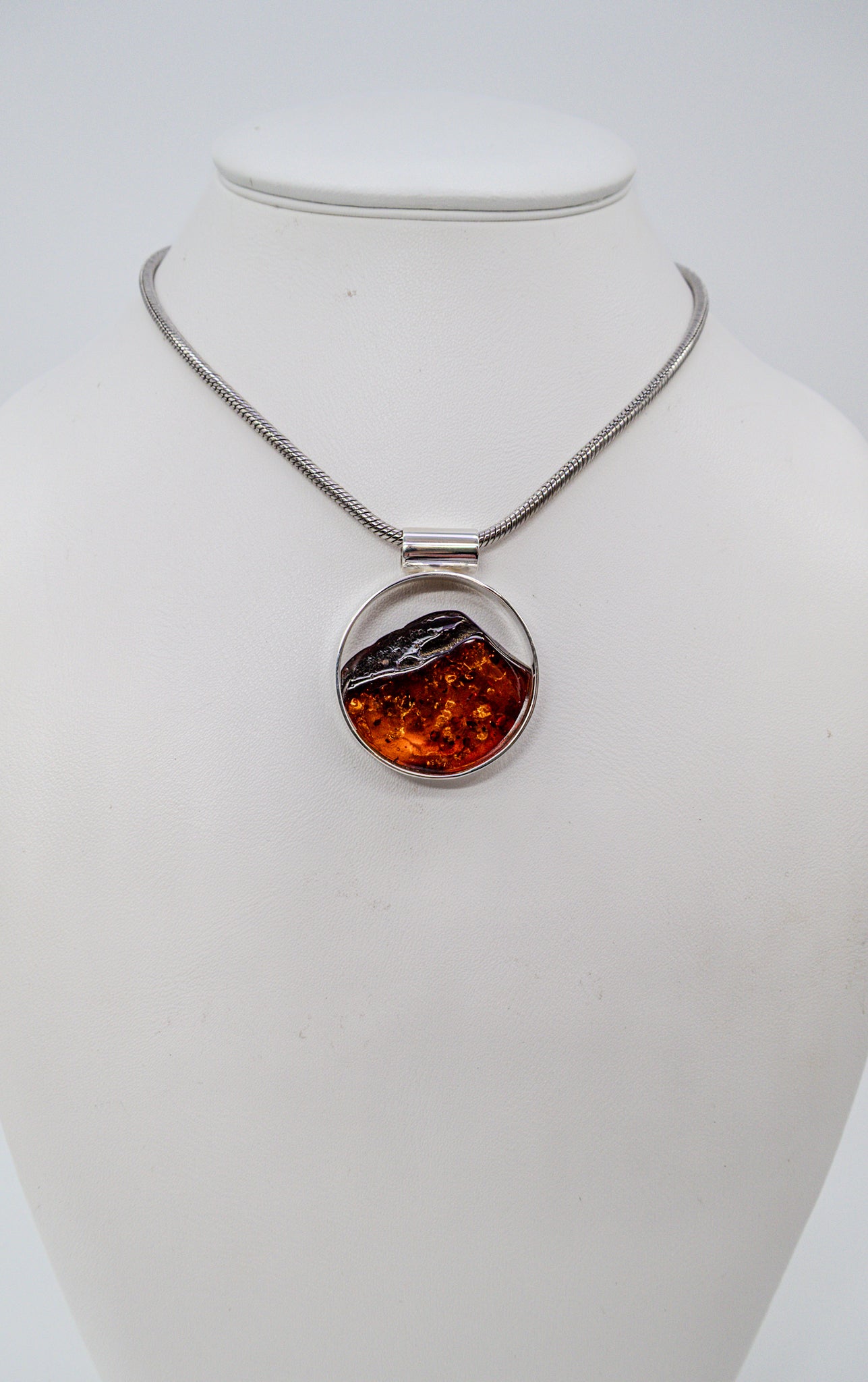 Modern silver pendant with genuine amber
