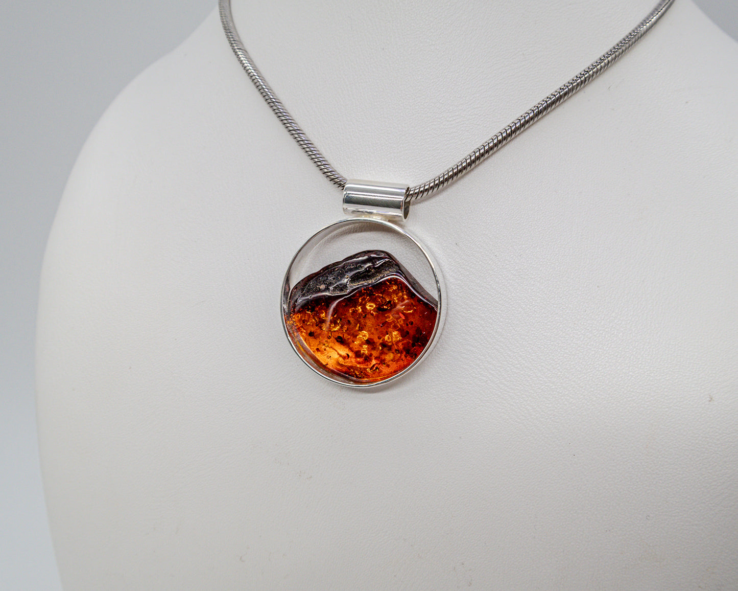 Modern silver pendant with genuine amber