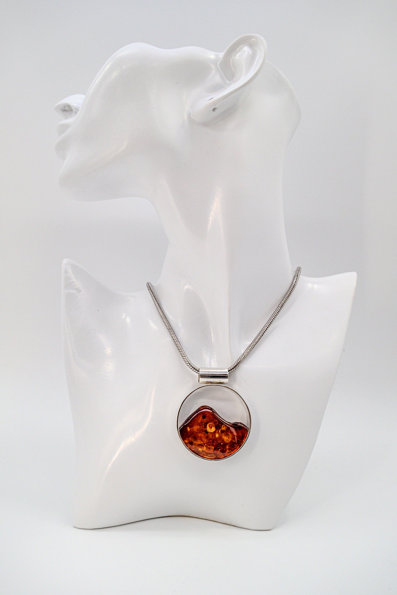 Unique pendant made of silver with amber