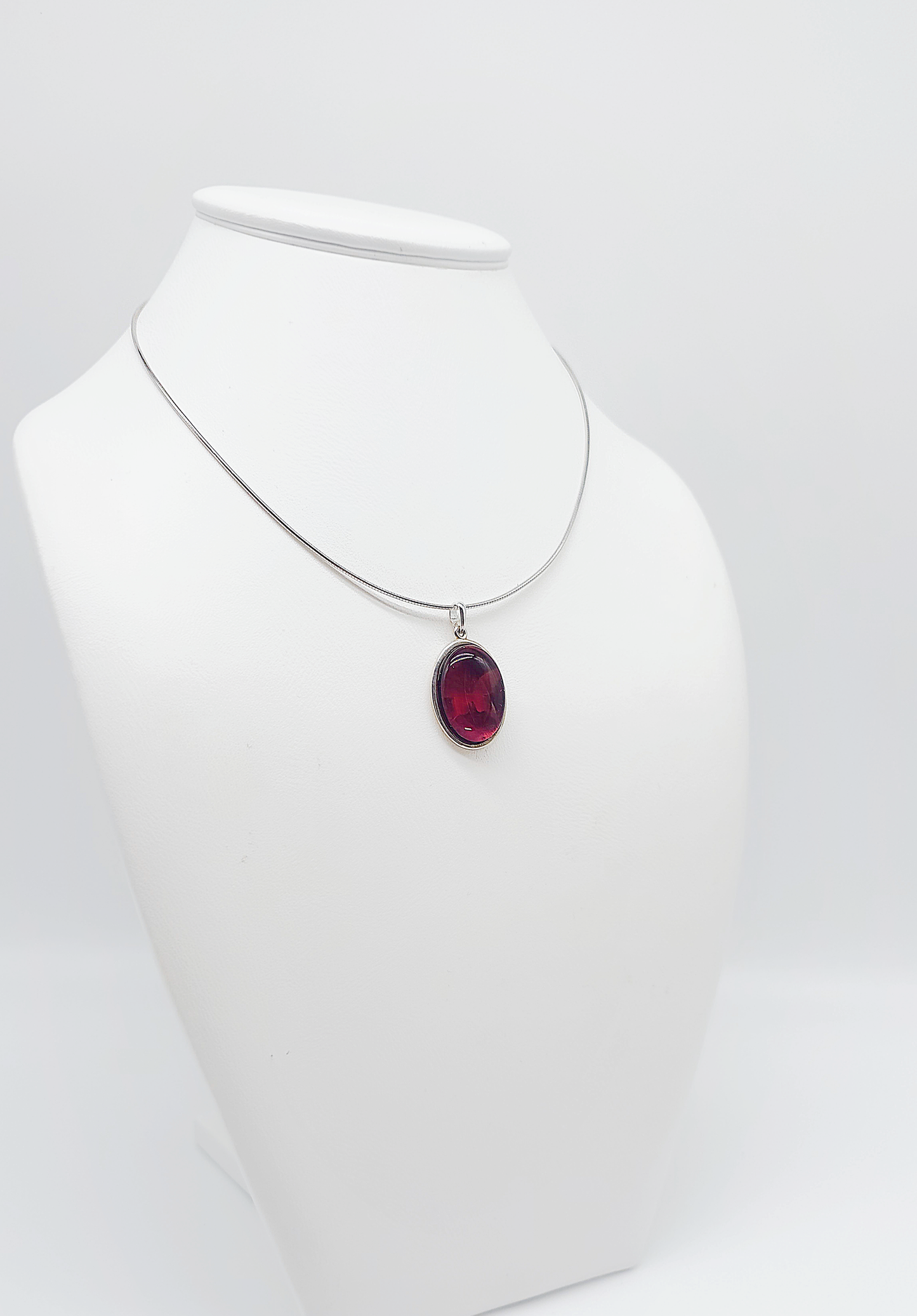 Silver pendant with red amber and butterfly design