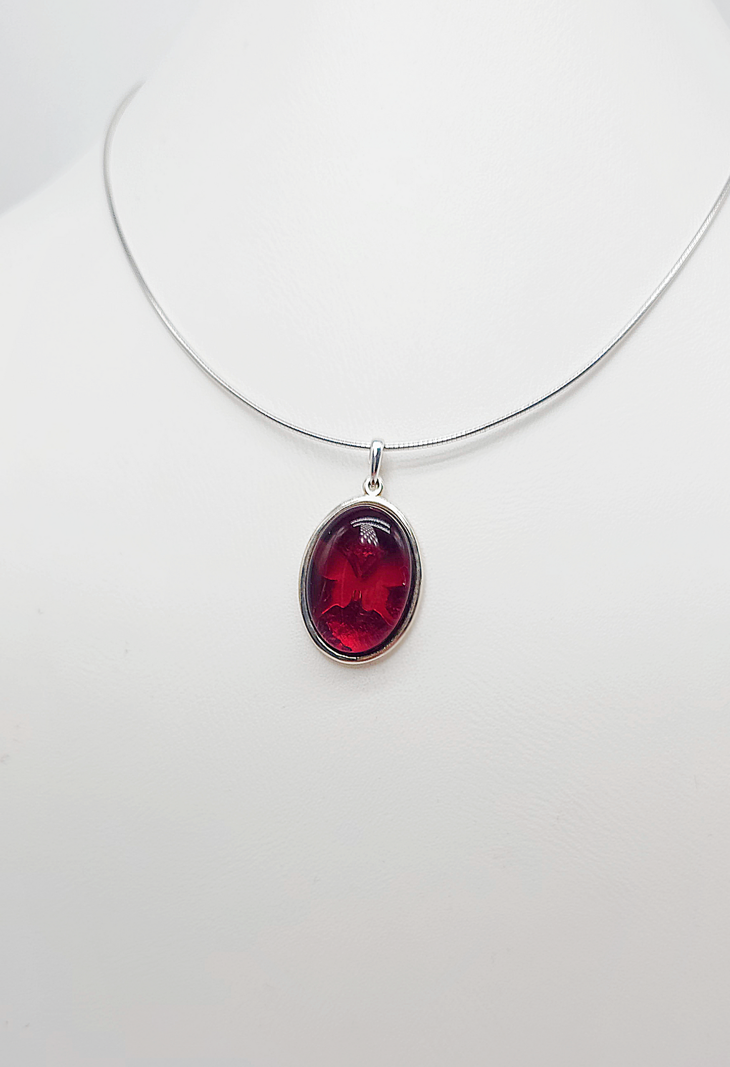 Silver pendant with red amber and butterfly design