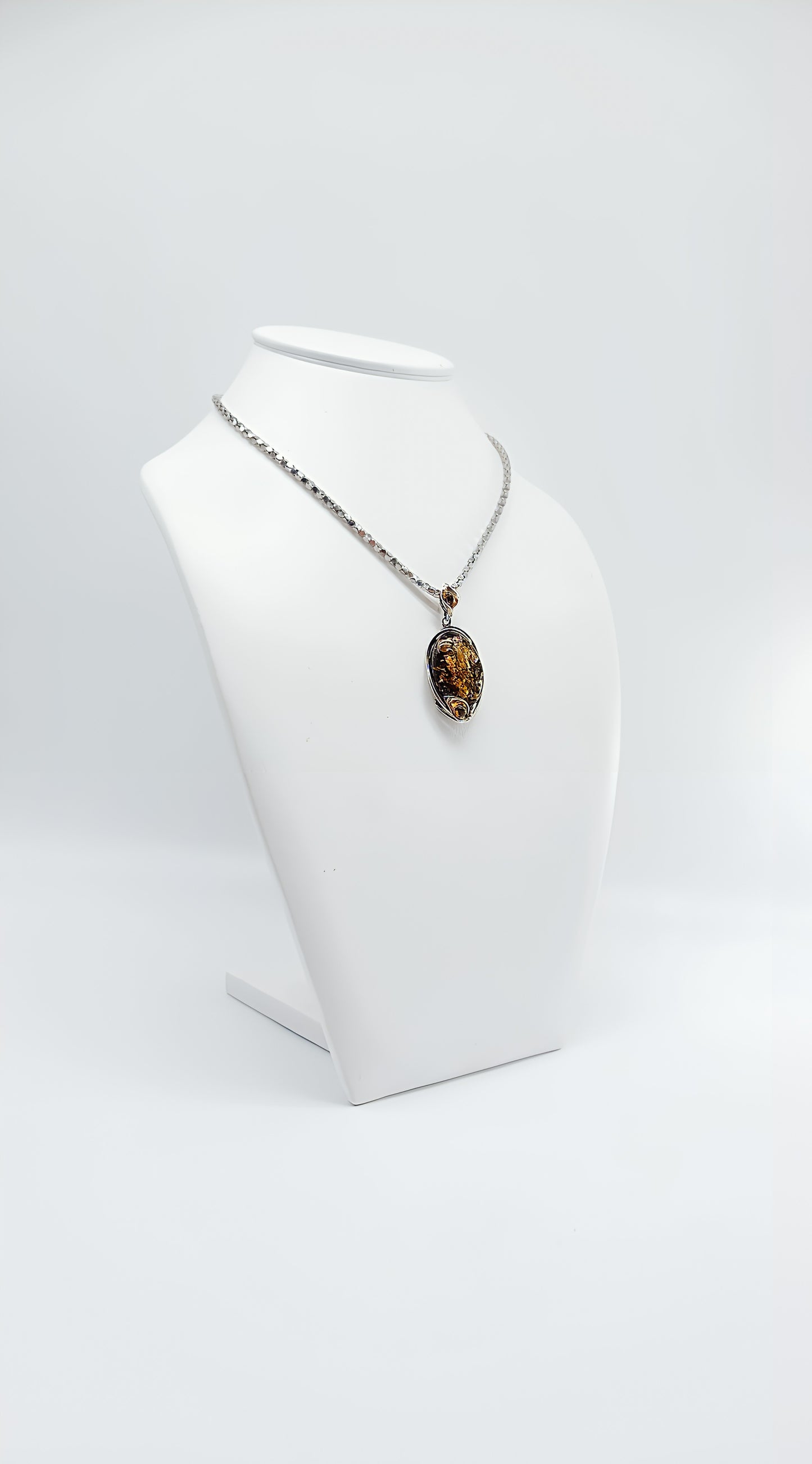 Antique elegance: amber pendant in silver