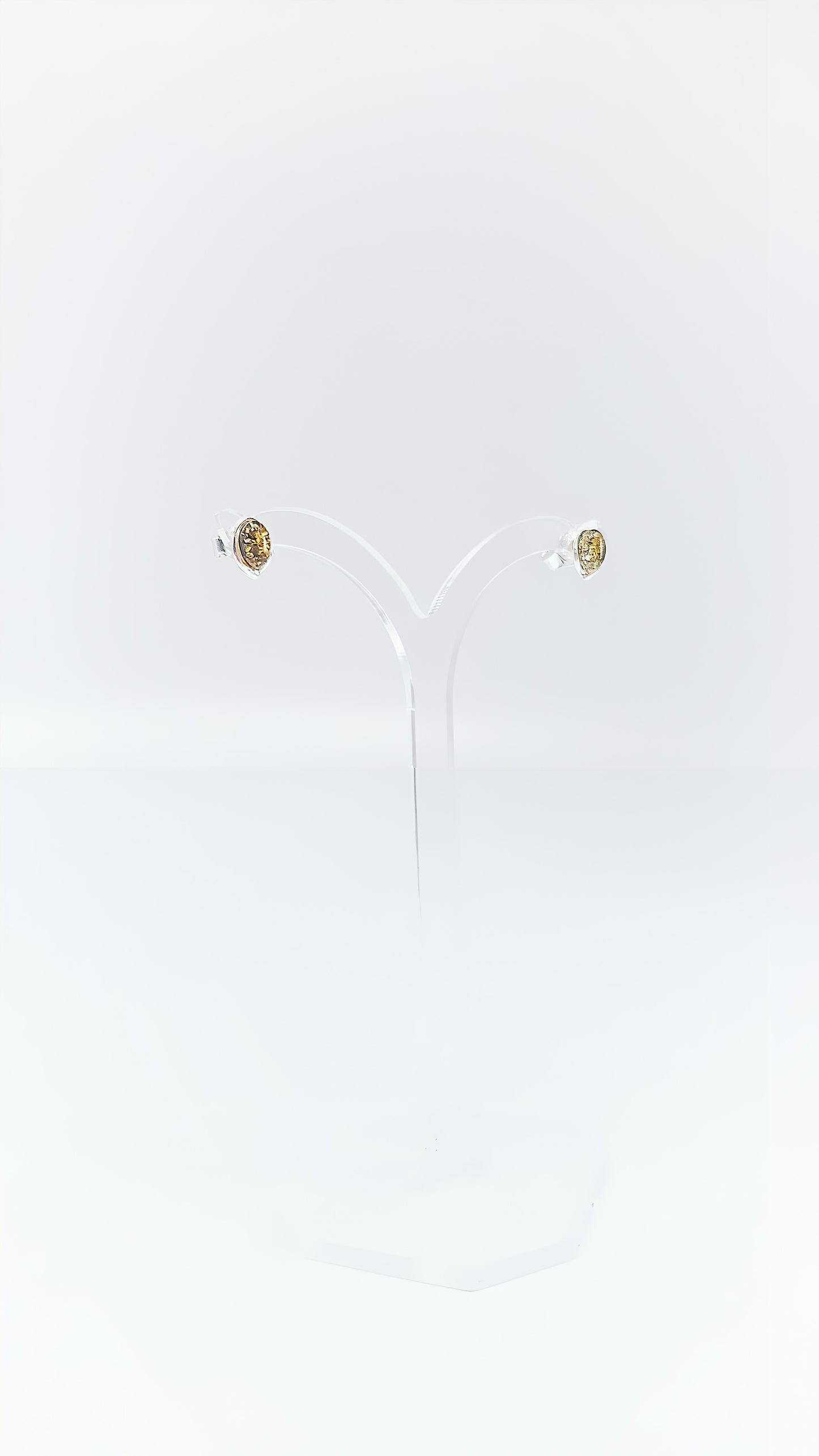 Oval amber earrings in a silver frame