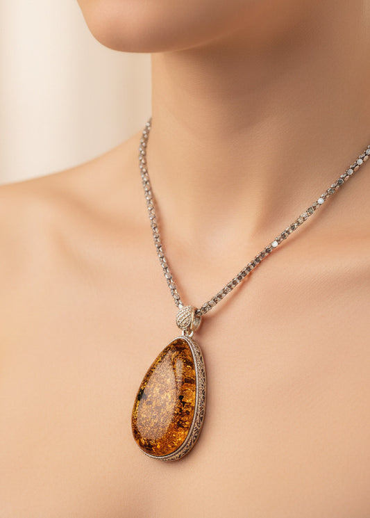 Natural amber pendant with filigree silver decoration