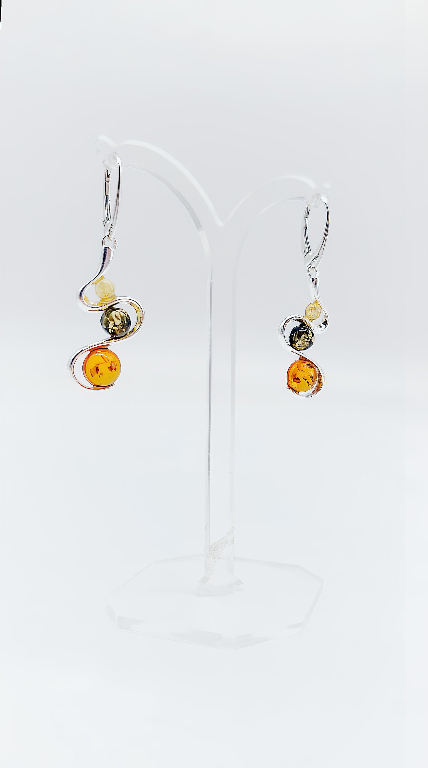 Three colors, one design: earrings with colorful amber