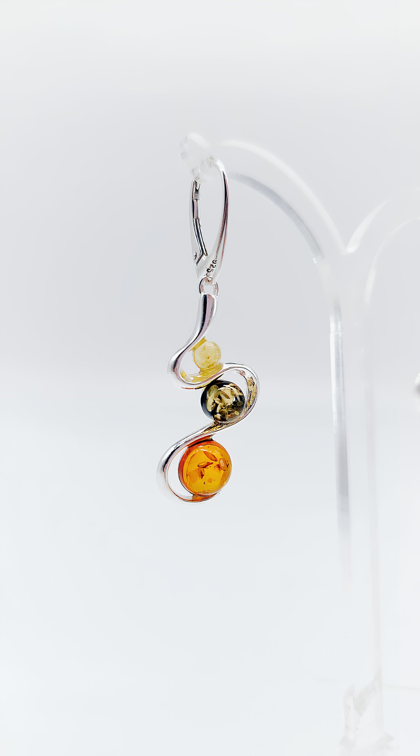 Three colors, one design: earrings with colorful amber