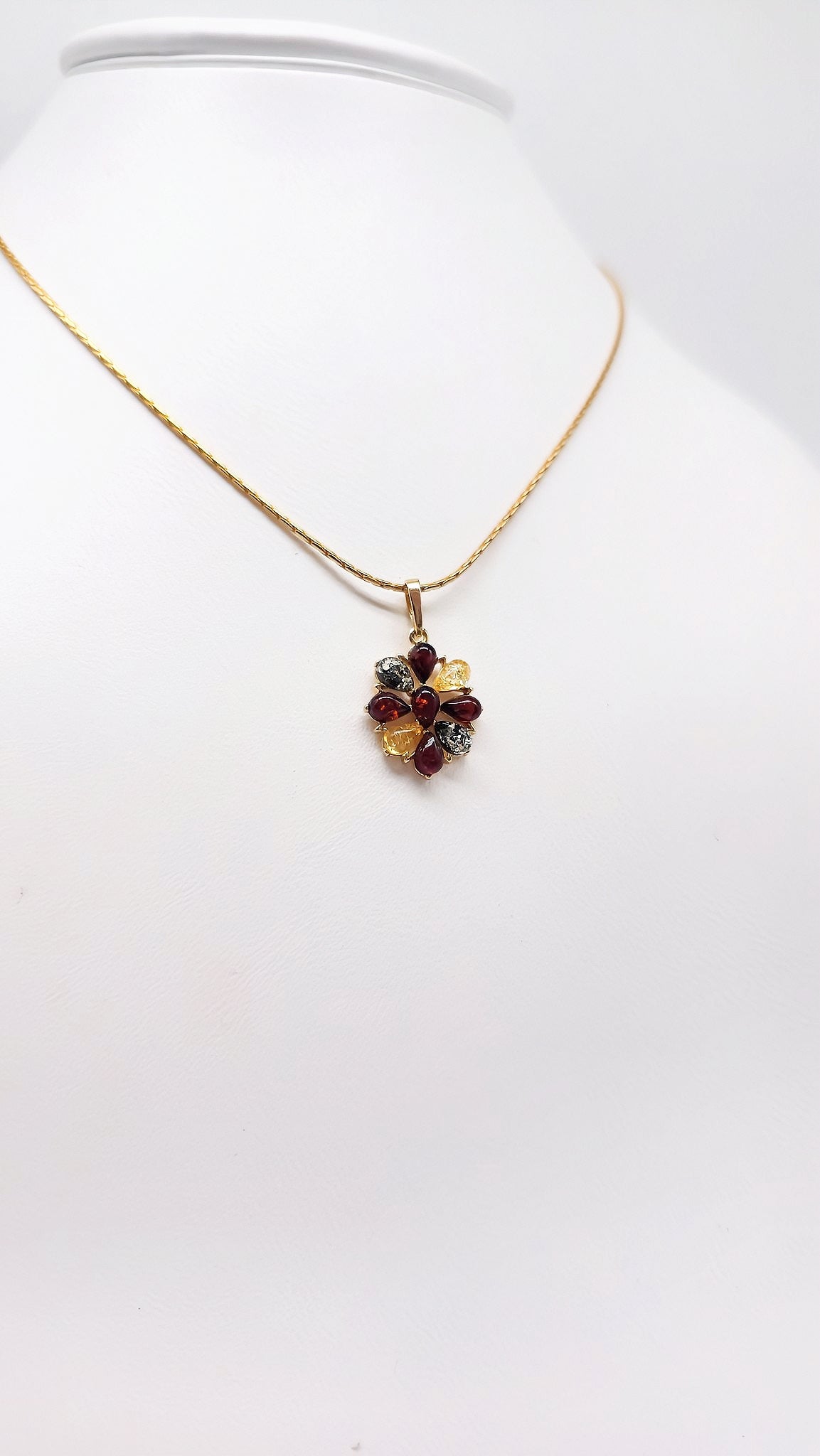 Natural charm: flower pendant with colored amber