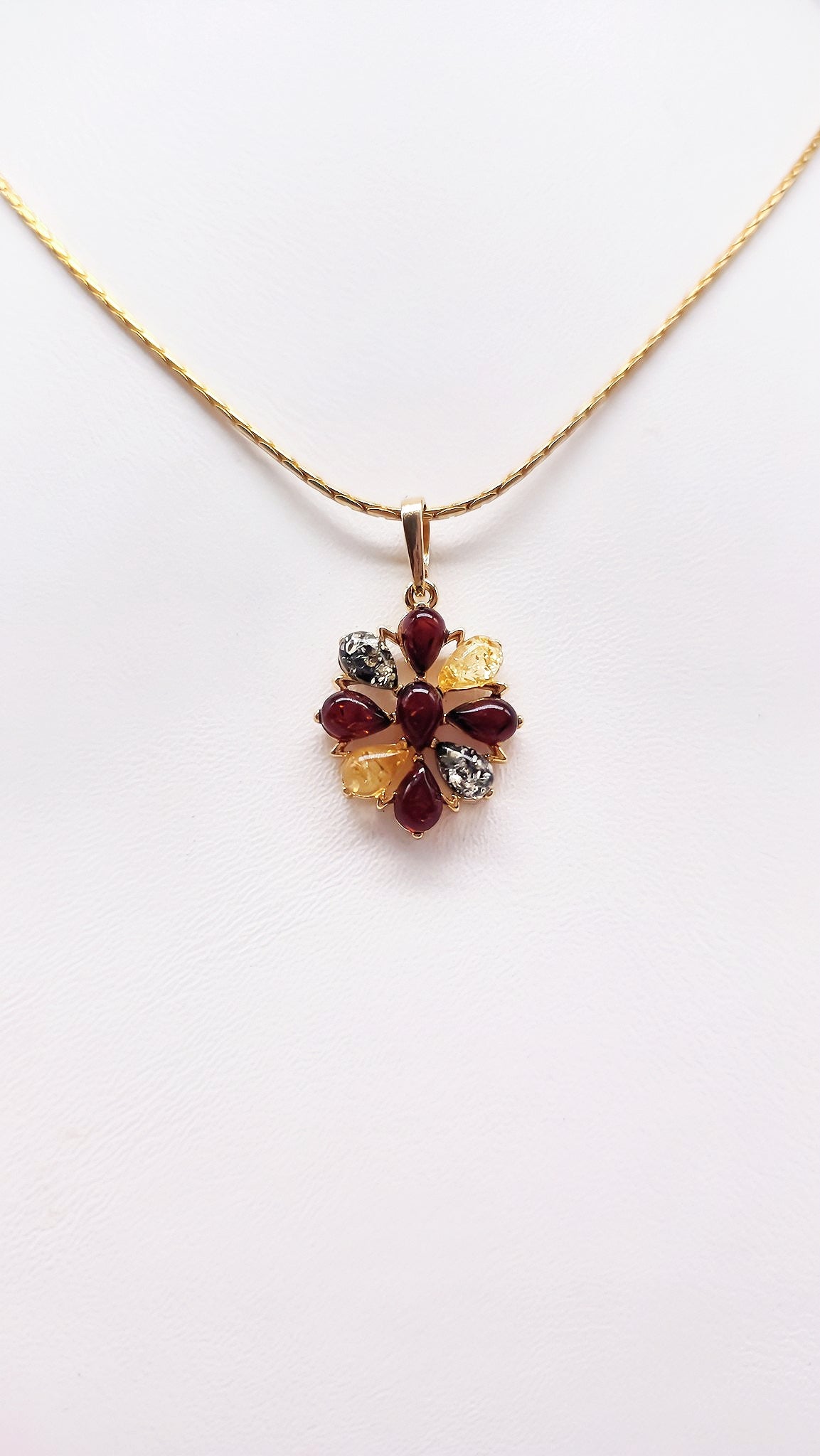 Natural charm: flower pendant with colored amber